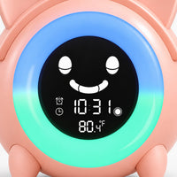 Écran LCD du réveil chat : visage souriant, heure et température